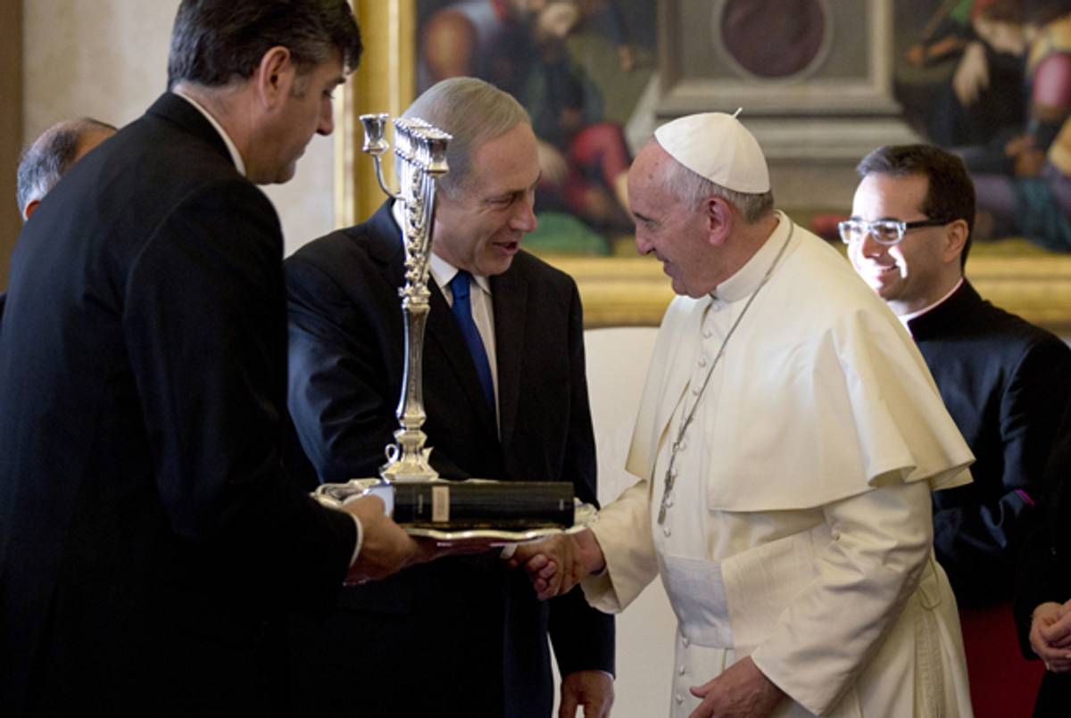 Israeli Prime Minister Benjamin Netanyahu offers a Menorah to Pope Francis (R) during a private audience at the Vatican, on December 2, 2013. (ALESSANDRA TARANTINO/AFP/Getty Images)