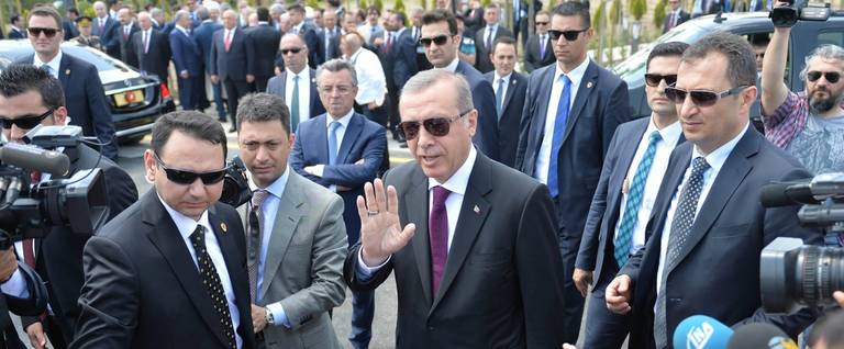 Turkish President Recep Tayyip Erdogan (C) greets supporters as he arrives for the inauguration of the Bayzid I Mosque (Yildrim Bayezid) at the Esenboga International Airport in Ankara, June 23, 2016. 