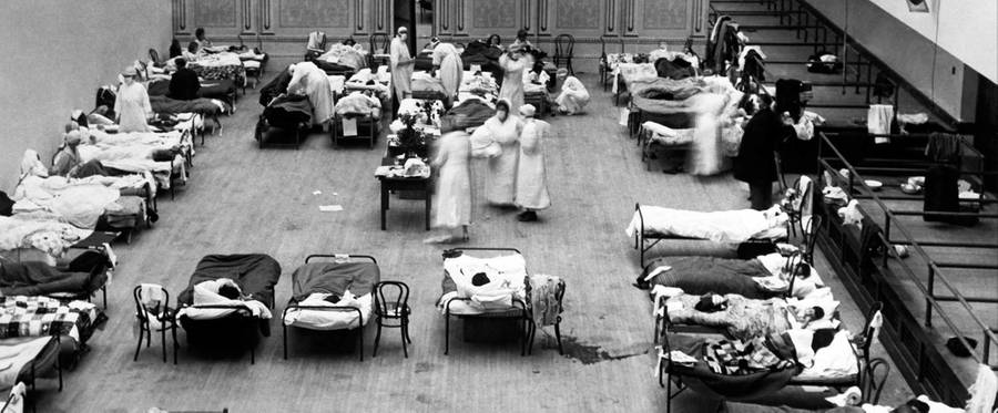 The Oakland Municipal Auditorium is being used as a temporary hospital with volunteer nurses from the American Red Cross tending the sick there during the influenza pandemic of 1918, Oakland, California. 