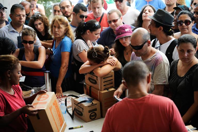 Israelis queue up as they wait to collect their gas masks at a distribution center in Tel Aviv on August 28, 2013. (DAVID BUIMOVITCH/AFP/Getty Images)