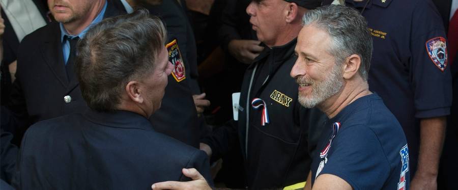 Jon Stewart (R) talks with first responders while visiting in Washington, D.C. to demand that Congress extend the Zadroga 9/11 health bill, September 16, 2015.  
