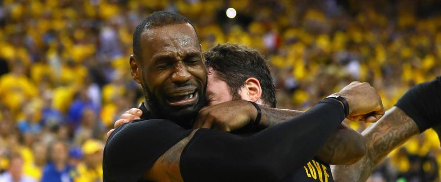 LeBron James (L) and Kevin Love of the Cleveland Cavaliers embrace after defeating the Golden State Warriors 93-89 in Game 7 of the 2016 NBA Finals at ORACLE Arena in Oakland, California, June 19, 2016. 