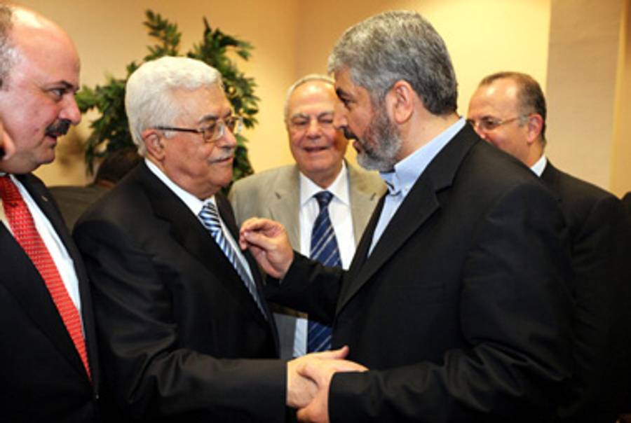 P.A. President Abbas (L) and Hamas leader Khaled Meshaal (R) in Cairo during happier times.(PPM via Getty Images)