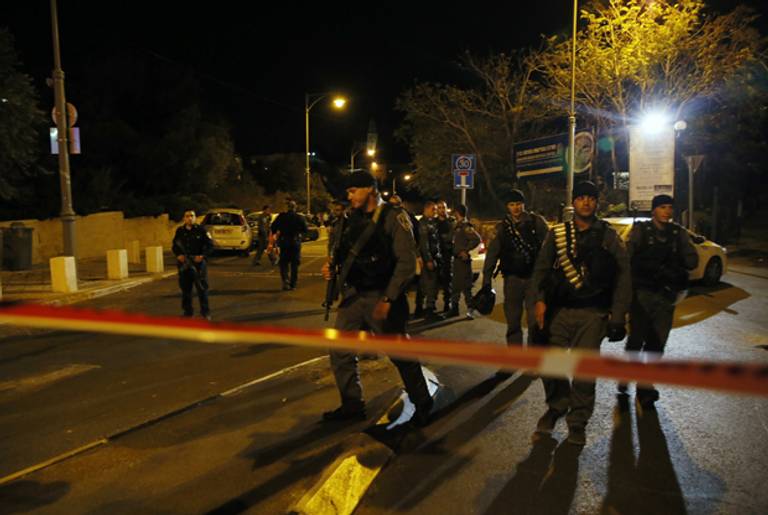 Israeli security forces stand behind a security perimeter after a Jewish activist was wounded during a shooting outside the Menachem Begin Heritage Center in Jerusalem on Oct. 29, 2014. (GALI TIBBON/AFP/Getty Images)
