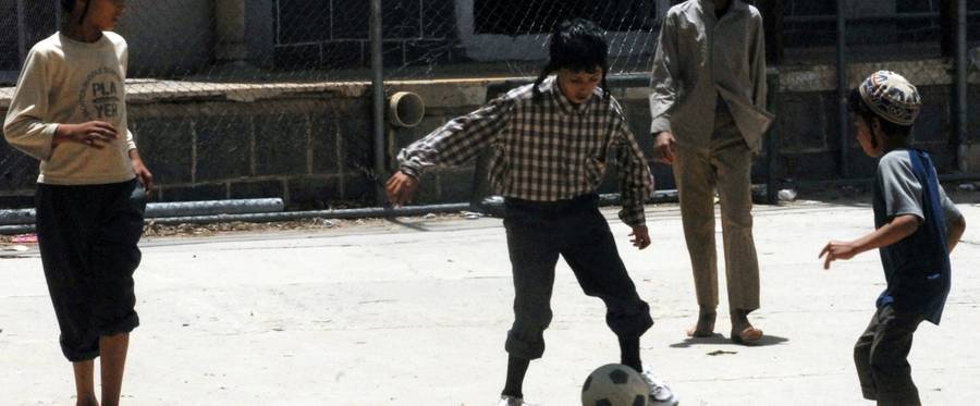 Yemeni Jewish youths play football at their temporary residence in the tourist city hotel compound in Sanaa, June 23, 2008. 