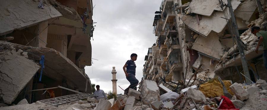 A Syrian boy walks on the rubble of destroyed buildings in the northern Syrian city of Aleppo on April 10, 2013.