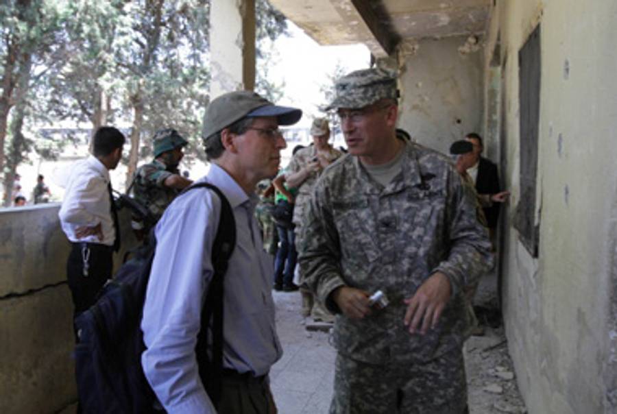 Ford in Syria with a U.S. military officer in June.(Louai Beshara/AFP/Getty Images)