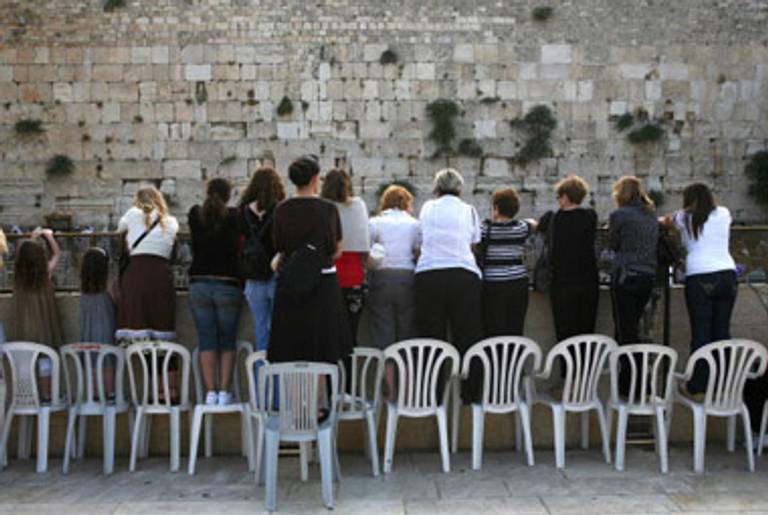 Women standing on chairs to view the Wall from a behind a barrier, 2007.(Menahem Kahana/AFP/Getty Images)