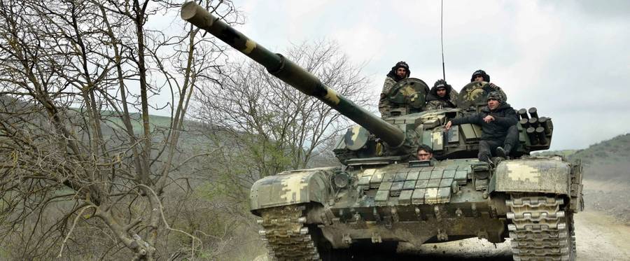 A tank of the defense army of Nagorny Karabakh moves on a road near the village of Mataghis, some 70km north of Karabakh's capital Stepanakert, on April 6, 2016.