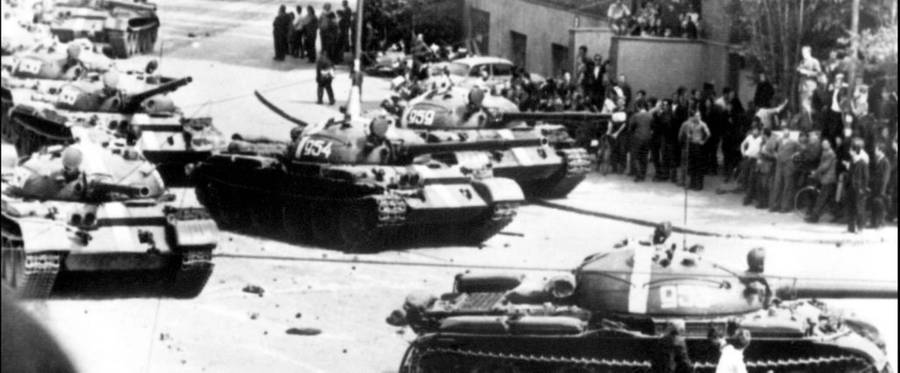 Prague residents shown in a file photo dated 21 August 1968 throwing stones at Soviet tanks entering the city.