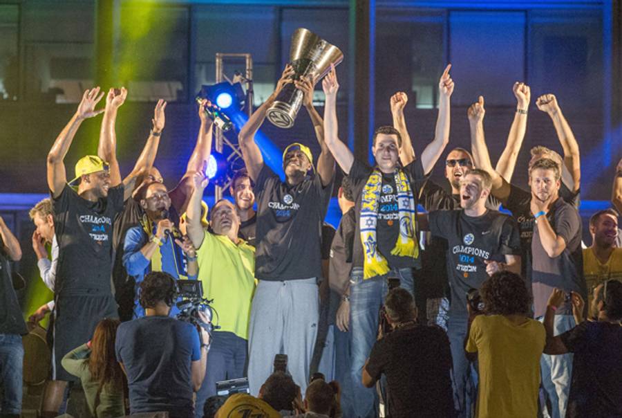 Maccabi Tel Aviv players celebrate in Rabin Square in Tel Aviv on May 19, 2014, following their victory over Real Madrid in the Euroleague 2014 Final Four basketball match in Milan, Italy. (JACK GUEZ/AFP/Getty Images)