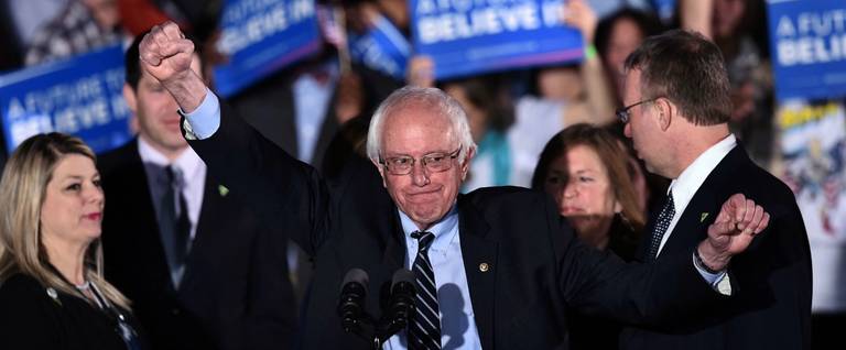 Democratic presidential candidate Bernie Sanders gestures on stage during a primary night rally in Concord, New Hampshire, February 9, 2016.