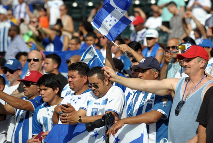 An Israeli soccer fan (R, red hat) waves a flag among Honduran fans before a friendly match between the two countries June 2, 2013 at Citi Field in the Queens borough of New York. (STAN HONDA/AFP/Getty Images)