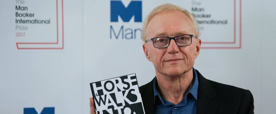 David Grossman poses for a photograph with his book 'A Horse Walks Into a Bar' at the shortlist photocall for the Man Booker International Prize at St James' Church in London, England, June 13, 2017.(Daniel Leal-Olivas/AFP/Getty Image)
