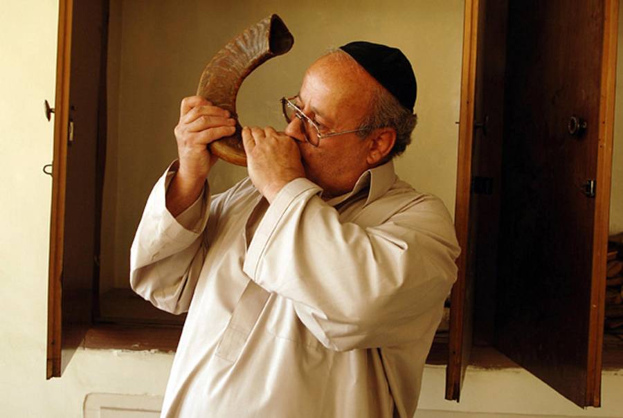 Zablon Simintov blows a ram’s horn at the sole synagogue in Kabul on Sept. 15, 2007. (Massoud Hossaini/AFP/Getty Images)