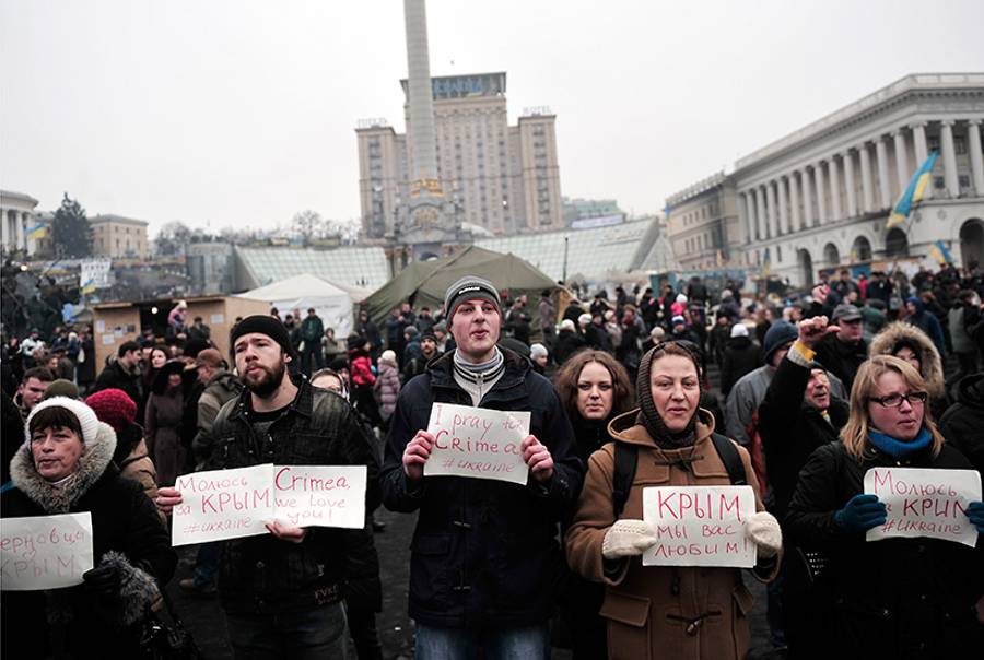 People hold placards reading 'I pray for Crimea #Ukraine' and 'Crimea we love you' during a rally on Independence Square in central Kiev on March 1, 2014. (Louisa Gouliamaki/AFP/Getty Images)