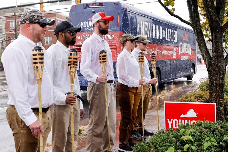 A small group assembled by the Lincoln Project dressed up as 'Unite the Right' rally-goers and pretended to support Republican candidate for governor of Virginia Glenn Youngkin at a campaign event in Charlottesville, Virginia, on Oct. 29, 2021