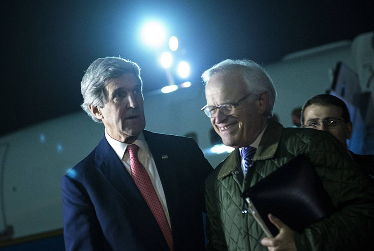 U.S. Secretary of State John Kerry and U.S. Special Envoy for Israeli-Palestinian Negotiations Martin Indyk return from a day trip to Jordan and Saudi Arabia at Ben Gurion International Airport on Jan. 5, 2014.(Brendan Smialowski/AFP/Getty Images)