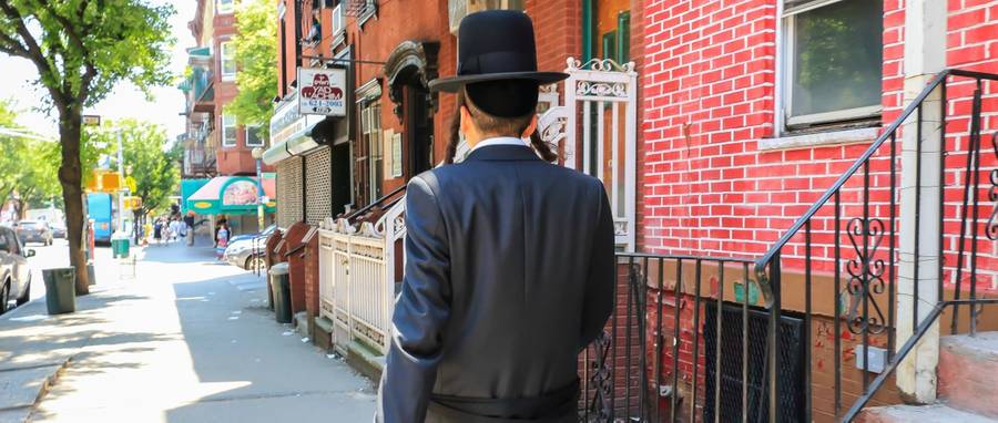 An Orthodox Jewish man walking in Brooklyn