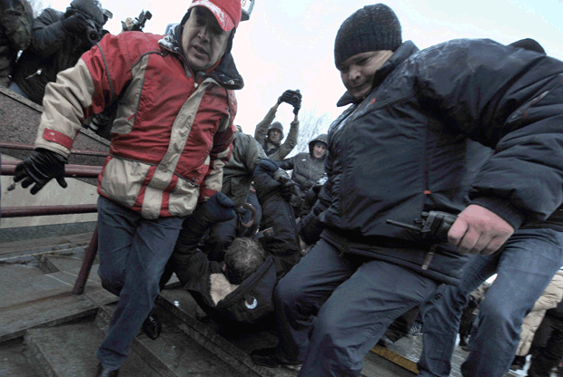 Plainclothes Belarusian police arrest an opposition supporter at a Day of Freedom rally in Minsk on March 25, 2011.(Viktor Drachev/AFP/Getty Images)
