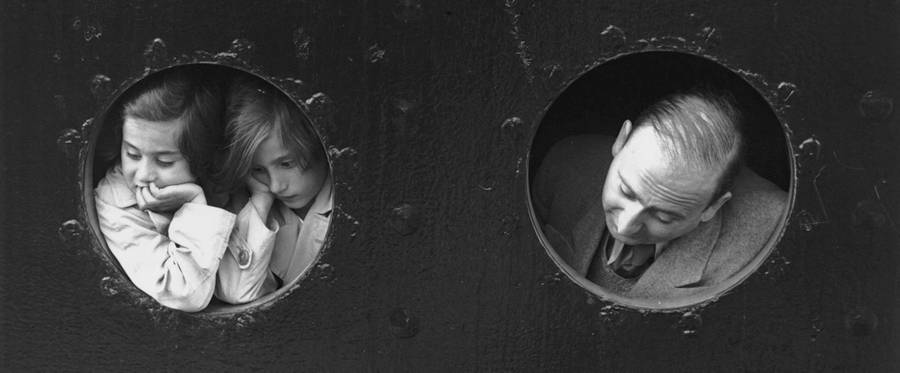 17th June 1939: German Jewish refugees, looking through portholes aboard the Hamburg-Amerika liner 'St Louis' on arrival at Antwerp, where a temporary home was found for the 900 refugees aboard. Most were later deported. 