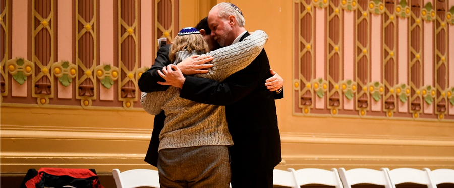 Rabbi Hazzan Jeffrey Myers, right, from the Tree of Life synagogue, hugs other rabbis who were leading services at the synagogue when it was attacked, during a vigil for the Pittsburgh massacre.