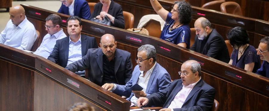 Israeli-Arab Member of Parliament Ahmed Tibi (front row, right) attends with fellow deputies the Knesset Plenary Hall session ahead of the vote on the National Law late on July 18, 2018 