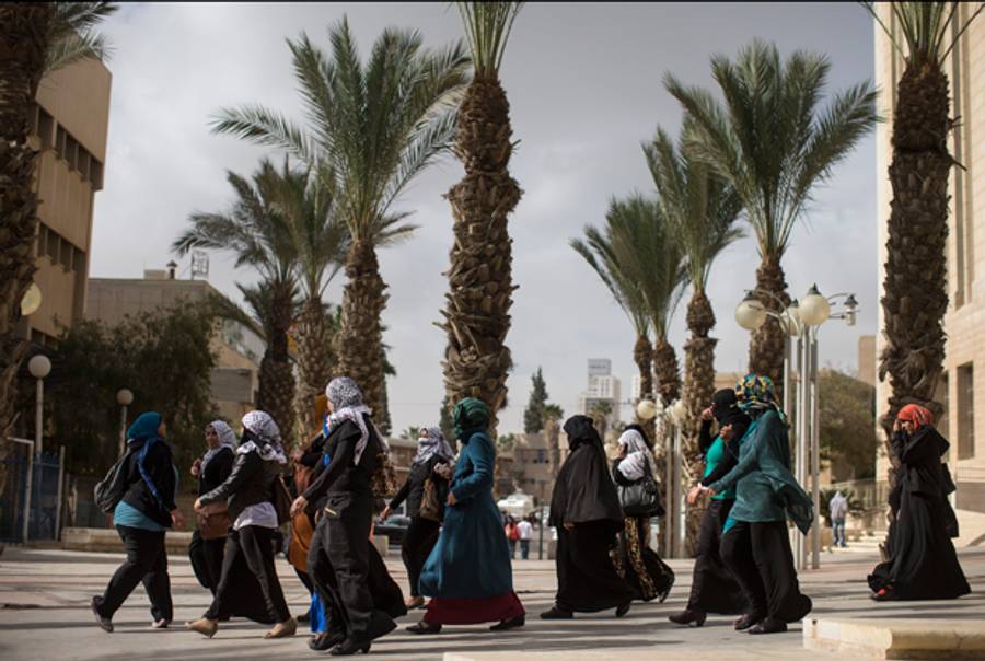  Women walk the street during a protest by Israeli Bedouins against the Israeli government's Prawer Plan as they gather outside an Israeli court and call for the release of fellow Bedouins arrested during last week's protest, on December 5, 2013 in Beer Sheva, Israel.(Uriel Sinai/Getty Images)