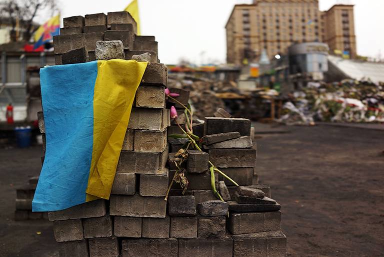 The Ukrainian flag is viewed on top of bricks used for barricades in Kiev's Maidan, the site of months of often violent protest that led to the ouster of former Ukrainian President Viktor Yanukovich on March 19, 2014.(Spencer Platt/Getty Images)