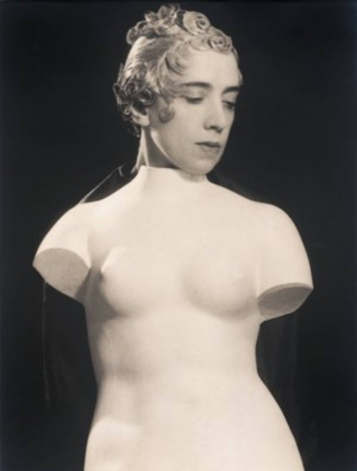 Elsa Schiaparelli poses for Man Ray in an Antoine wig. (Man Ray, Untitled, ca. 1933, Collection San Francisco Museum of Modern Art © Man Ray Trust / Artists Rights Society (ARS), New York / ADAGP, Paris)