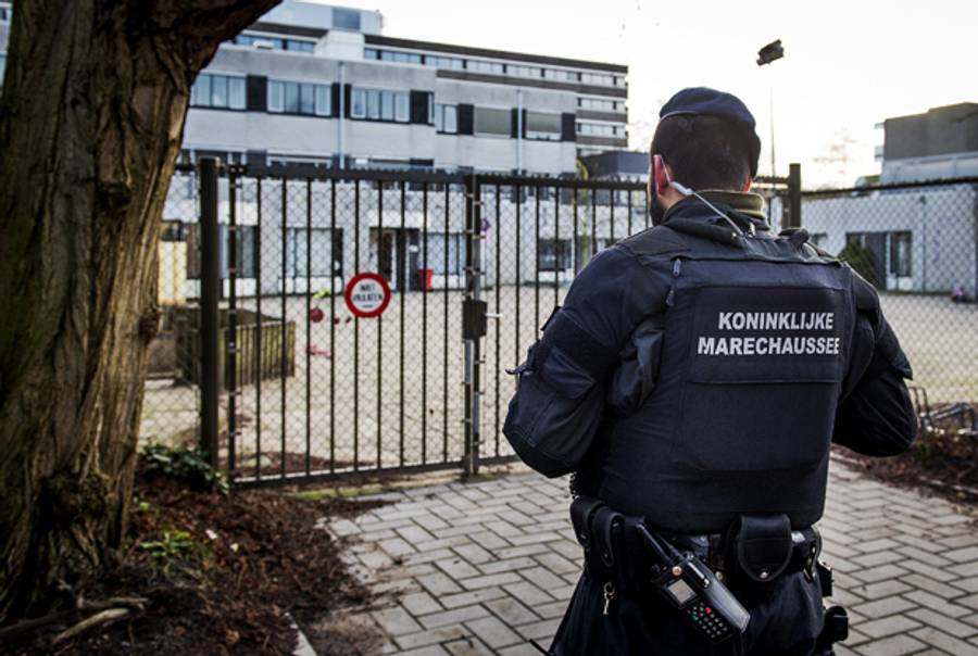 A member of the Royal Netherlands Marechaussee stands guard outside the Jewish Children Community Cheder, Netherlands' only Orthodox Jewish school in Amsterdam on January 16, 2015 after Belgian police arrested 13 people during a dozen raids overnight. (Koen van Weel/AFP/Getty Images)