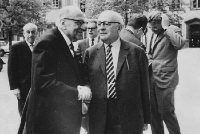 Max Horkheimer (left) and Theodor Adorno (right), with Jürgen Habermas and others in the background, right, in 1965 at Heidelberg.(Wikimedia Commons)