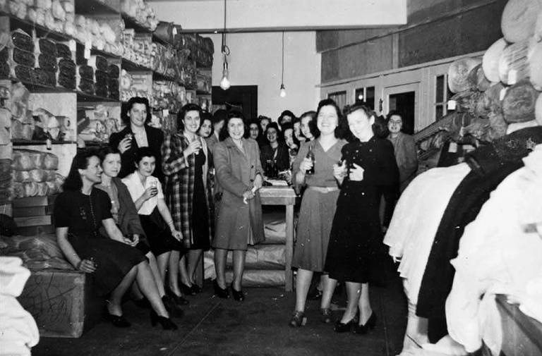 Seattle Curtain employees celebrating in stock area, Seattle, circa 1932-1941