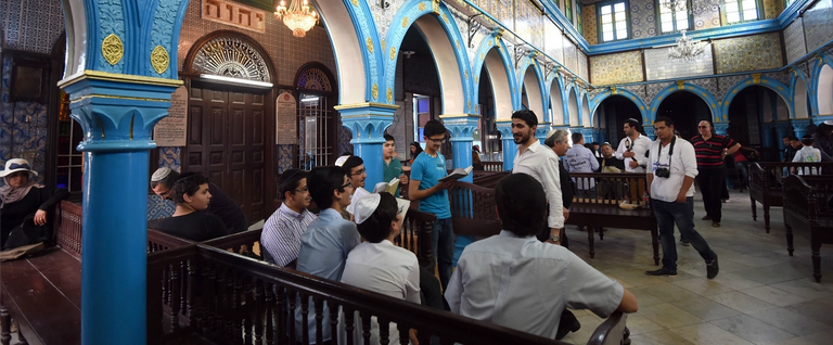 Young Tunisian Jews read the Torah, Judaisms most important text, at the Ghriba synagogue on the Tunisian resort island of Djerba on May 6, 2015, at the start of a two-day annual pilgrimage. 
