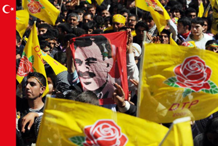 Kurdish Turks hold a poster of jailed rebel leader Abdullah Ocalan during a celebration of the Kurdish New Year in the southeastern Turkish city of Diyarbakir, March 21, 2009.(Mustafa Ozer/AFP/Getty Images)