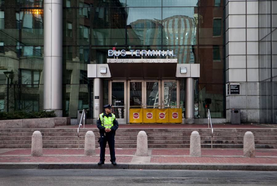 A police officer stands guard at South Station on April 19, 2013 in Boston, Massachusetts.(Kayana Szymczak/Getty Images)