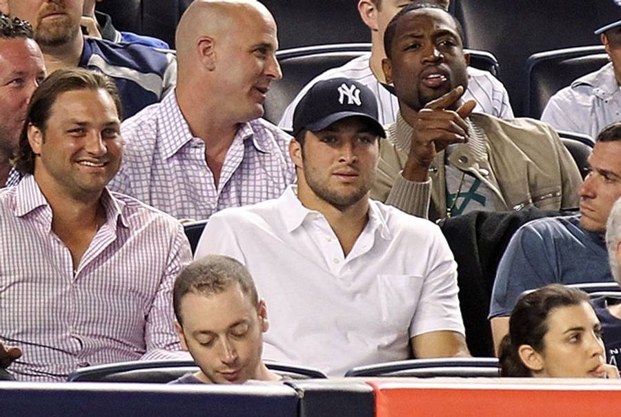 Tim Tebow at Yankee Stadium. (Yes that is Dwyane Wade behind him.)(Nick Laham/Getty Images)