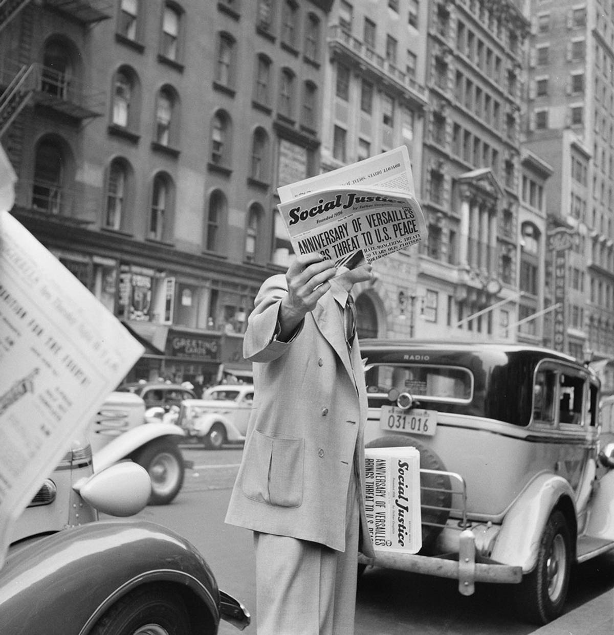 ‘Social Justice,’ founded by Father Coughlin, sold on important street corners and intersections. New York City, 1939. (Photo: Dorothea Lange/Library of Congress)