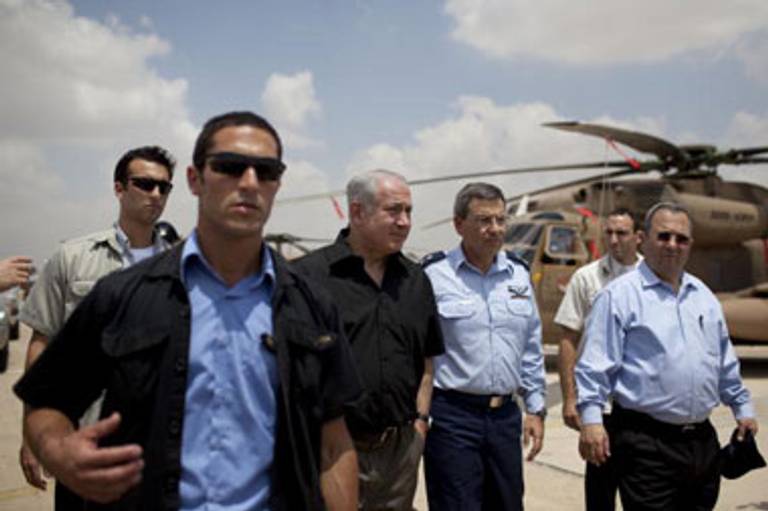 Netanyahu, accompanied by Defense Minister Ehud Barak, at right, tours Hatzerim air base Tuesday.(Uriel Sinai/Getty Images)
