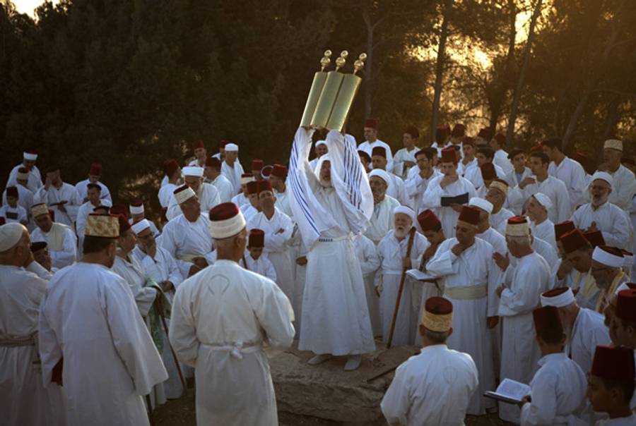 A Samaritan high priest raises a Torah scroll during Sukkot celebrations on Mount Gerizim on Oct. 11, 2011.(Menahem Kahana/AFP/Getty Images)