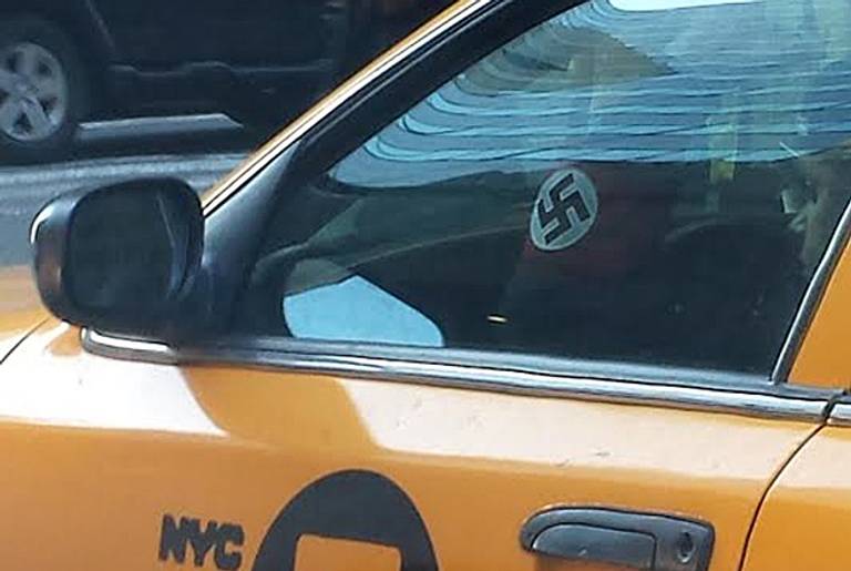 NYC cab driver photographed wearing swastika armband. (ADL)