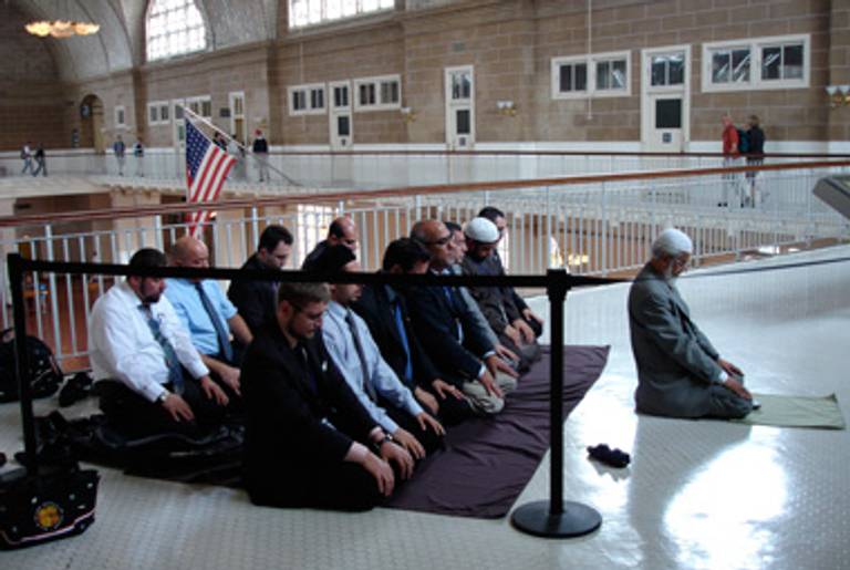The imams praying on the balcony of Ellis Island's Great Hall.(Allison Hoffman)