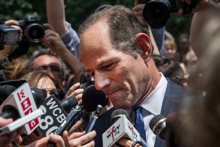 Former New York Gov. Eliot Spitzer is mobbed by reporters on July 8, 2013, while attempting to collect signatures to run for comptroller of New York City.(Andrew Burton/Getty Images)
