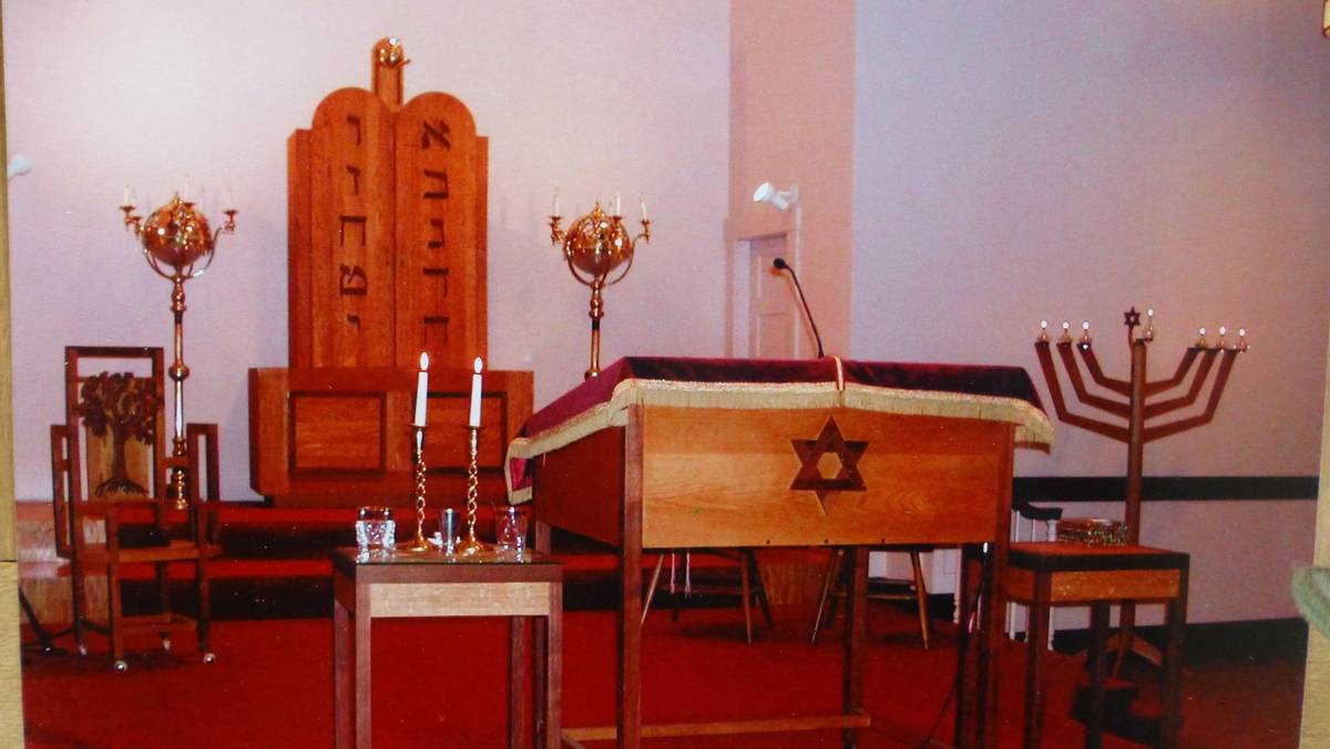 The bima of Beth El, featuring the handmade wooden ark that found a permanent home in a former church. (Image courtesy of Congregation Beth El)