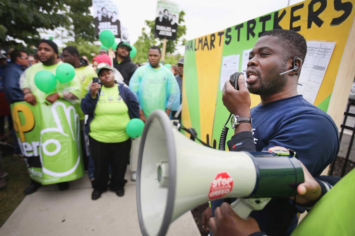 Walmart workers and union activists protest as part of a campaign to raise wages outside a Walmart store in Chicago on June 4, 2014