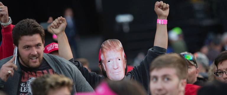 A supporter of Republican presidential candidate Donald Trump wears a mask during his campaign rally at the Orange County Fair and Event Center in Costa Mesa, California, April 28, 2016. 