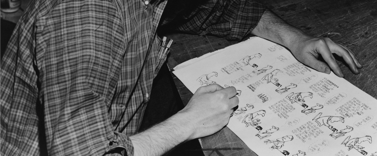 Jules Feiffer, American cartoonist, seated with proof sheets from 'Sick, Sick, Sick' (1958), his first book.