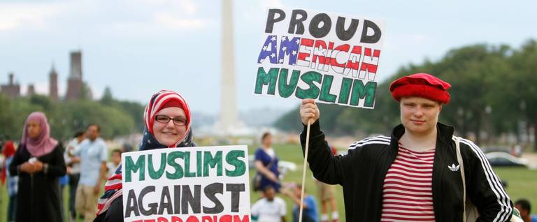Two people take part in the Americans Against Terrorism, Hate and Violence rally on the National Mall in Washington, D.C, where more than 30 prominent Interfaith, Social NGOs and ethnic organizations including Muslim, Christian, Jewish, Buddhist, Sikh, Hindu, and Bahai religions sponsored a rally, July 23, 2016. 