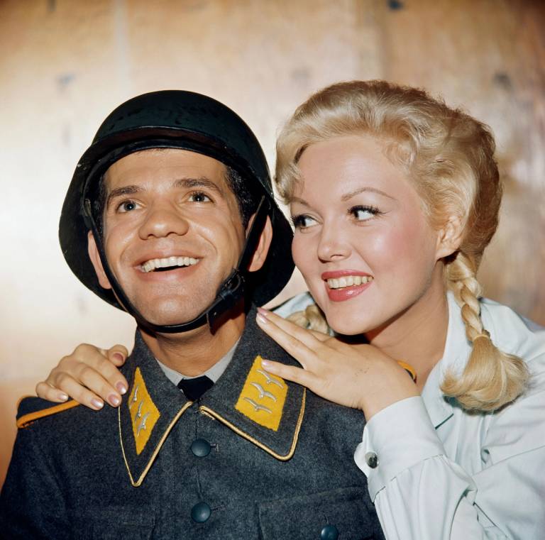 Robert Clary, as Corporal Louis LeBeau, and Cynthia Lynn, as Helga, star in 'Hogan's Heroes,' 1965