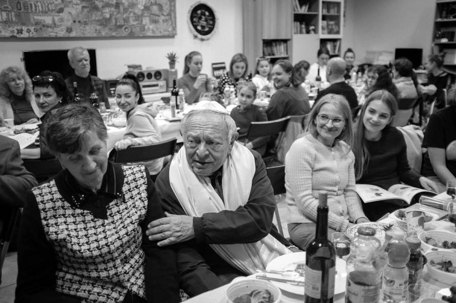 Yaakov Tamarkin, a Ukrainian refugee from Vasilkov, at center, and members of his family attend a Passover Seder at the Jewish Community Center in Krakow, 2022